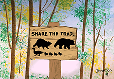 Art piece of a sign on a trail saying "Share the trail" that shows wildlife