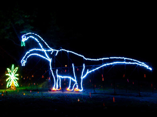 LED silhouette of a dinosaur eating leaves from a tree