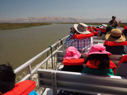 SALT MARSH SAFARI​ with tourists on a boat in life jackets