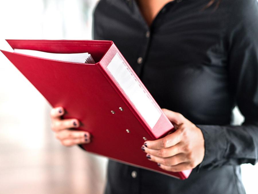 Closeup of someone holding a binder