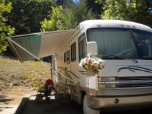 RV with overhang and fresh flowers