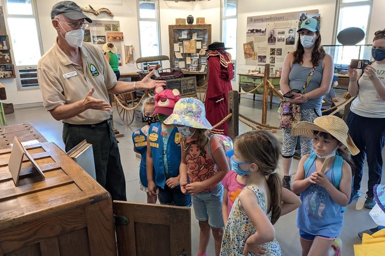 Volunteer chats with girl scouts